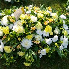 White and yellow casket spray